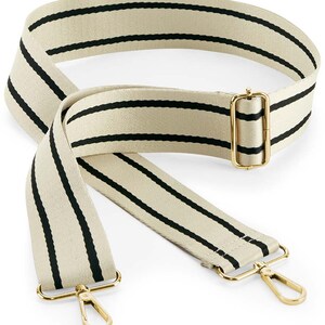 May include: A beige and black striped adjustable strap with gold metal hardware. The strap has two swivel clips on the ends.