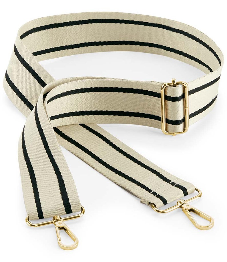 May include: A beige and black striped adjustable strap with gold metal hardware. The strap has two swivel clips on the ends.