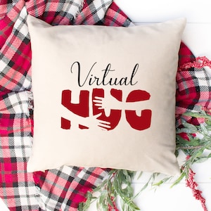 May include: A white cushion with the text "Virtual Hug" in black lettering. The word "Hug" is in red and features a stylised image of two arms hugging.