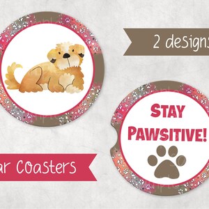 May include: Two car coasters with a paw print design. One coaster features a brown and white dog with the text "Car Coasters". The other coaster features a brown paw print and the text "Stay Pawsitive!"