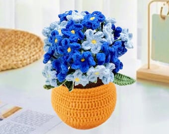 May include: A crocheted flower arrangement in a small orange pot. The flowers are blue and light blue with yellow centers.