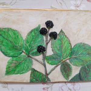 May include: A close-up of a framed artwork depicting a stylized black bramble with green leaves on a cream background.