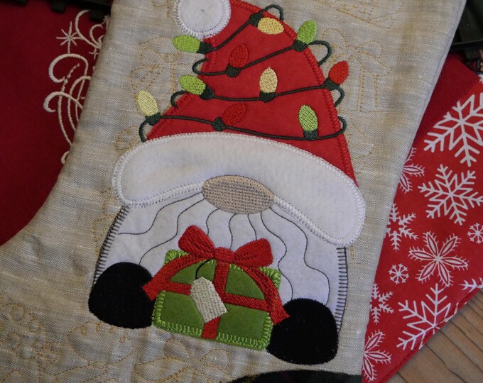 Christmas sock with embroidered Gnome from green natural linen and colored cotton for holiday decoration and Advent gift