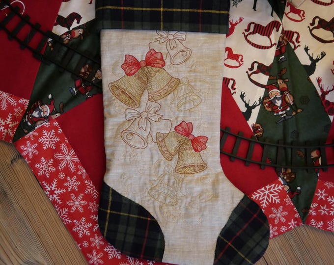 Christmas sock with embroidered Gnome from green natural linen and colored cotton for holiday decoration and Advent gift