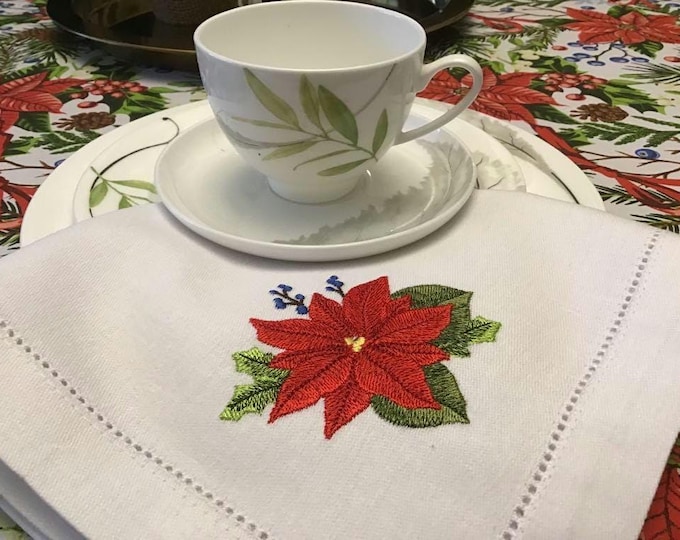 Napkins with embroidered Christmas poinsettia and tablecloth with Christmas poinsettia