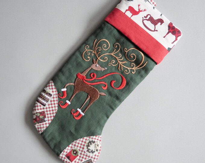 Christmas sock with embroidered Deer from green natural linen and colored cotton for holiday decoration and Advent gift