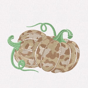 May include: An embroidery design featuring two pumpkins with a tan and brown camouflage pattern. The pumpkins are accented with light green embroidered stems and curling vines, rendered in a detailed stitch pattern on a white fabric background.