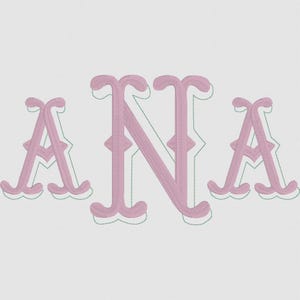 May include: Pink embroidered monogram of the letters "ANA" on a white background. The letters have a decorative, vintage style with a scalloped edge and a green outline. The "N" is slightly larger than the "A"s.