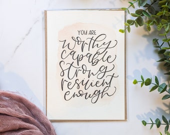 May include: A card with a watercolor background and the text "You are worthy capable strong resilient enough" written in black calligraphy.
