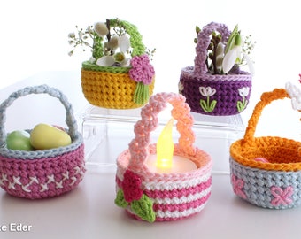 May include: Five crocheted baskets in different colors and designs. The baskets are decorated with flowers, a butterfly, and a tea light. The baskets are perfect for Easter or spring decor.