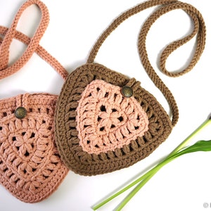 May include: Two crocheted triangle-shaped purses with brown and pink yarn. The purses have a strap and a button closure.