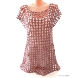 May include: A mauve crochet top with a loose, open-weave design and short sleeves.