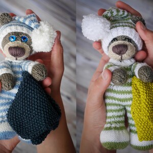 May include: Two knitted teddy bears wearing striped pajamas and hats. One bear is holding a blue blanket and the other is holding a yellow blanket.
