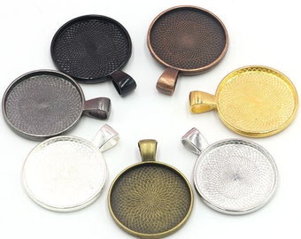 May include: Set of seven round metal pendant trays in various finishes, including black, silver, gold, and bronze. Each tray has a decorative swirl pattern and a loop for hanging.