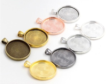 May include: Assortment of seven round pendant trays in various metallic finishes, including silver, gold, bronze, and black. Each tray has a decorative swirl pattern and a bail for attaching a chain.