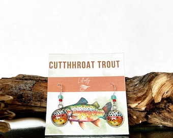 May include: Cutthroat Trout earrings with a watercolor image of a trout on a white card with the text "Cutthroat Trout" and "Lilfly".
