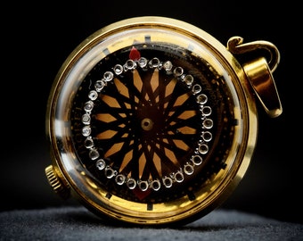 1967 Ernest Borel “Cocktail 4331” Kaleidoscope Mechanical Pendant Watch, 40 Microns Yellow Gold Electroplate, Jeweled Crystal, Skeleton Back