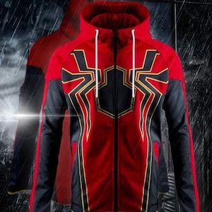 May include: Red and black zip-up hoodie with a spider web design on the front. The hoodie has a black hood with a white drawstring.