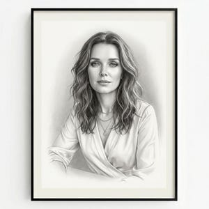 May include: A monochrome pencil portrait, framed in black, depicting a woman with flowing, wavy hair. She wears a white wrap blouse and a delicate necklace. The portrait is set against a neutral background.