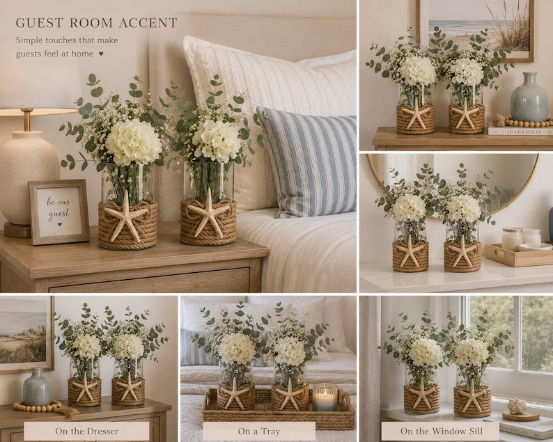 May include: Two clear glass cylindrical vases wrapped in thick tan jute rope, each featuring a single beige starfish centered on the front. The vases are filled with white hydrangea flowers and green eucalyptus stems, creating a floral arrangement.