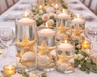 May include: Elegant table setting with glass cylinders filled with water, starfish, and seashells. Floating candles illuminate the centerpiece, surrounded by flowers and glassware, creating a romantic ambiance for a special event.