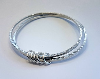 Double square silver bangle with 5 small rings.