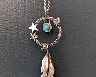 A silver feather and Turquoise necklace.