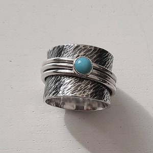 A gorgeously textured wide turquoise spinner ring.