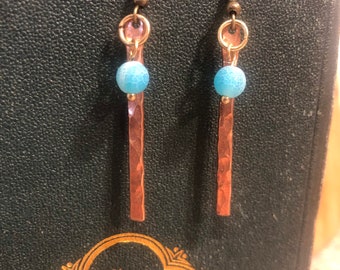 Hand-Forged Copper Earrings Adorned with Turquoise Charms, Embodying Rustic Elegance and Minimalist Charm