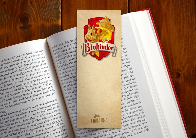 May include: A brown bookmark with a red and gold shield featuring a cartoon bunny rabbit. The shield has the text "Binkindor" in gold lettering. The bookmark is made of paper and has a distressed look. The text "FIRLEFANZ" is printed in the bottom right corner.