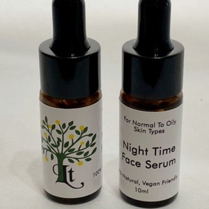 May include: Two amber glass bottles with black dropper tops and white labels. The label on the left bottle says "It" and "100%". The label on the right bottle says "For Normal To Oily Skin Types", "Night Time Face Serum", "100% Natural, Vegan Friendly", and "10ml".