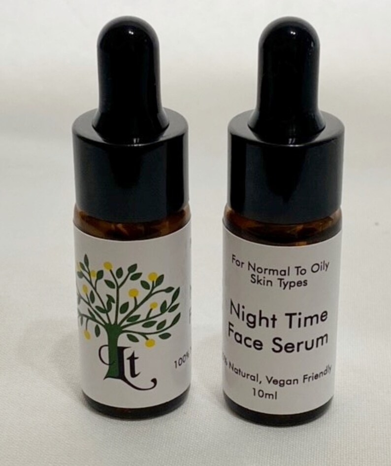 May include: Two amber glass bottles with black dropper tops and white labels. The label on the left bottle says "It" and "100%". The label on the right bottle says "For Normal To Oily Skin Types", "Night Time Face Serum", "100% Natural, Vegan Friendly", and "10ml".