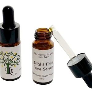 May include: Two amber glass bottles with black dropper tops and white labels. The label on the bottle on the right reads "For Normal To Oily Skin Types Night Time Face Serum 100% Natural, Vegan Friendly 10ml".