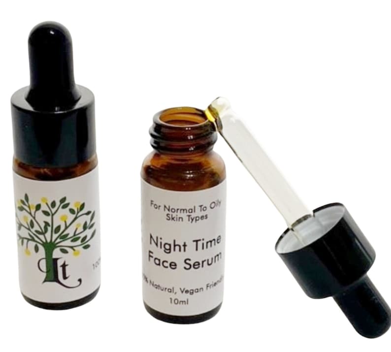 May include: Two amber glass bottles with black dropper tops and white labels. The label on the bottle on the right reads "For Normal To Oily Skin Types Night Time Face Serum 100% Natural, Vegan Friendly 10ml".