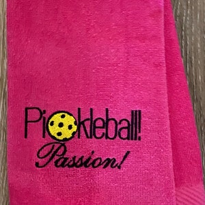May include: Pink towel with black embroidery that reads "Pickleball! Passion!" and a yellow pickleball graphic.