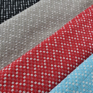 May include: Four fabric swatches with a checkered pattern. The swatches are black and white, beige, red and white, and light blue and white.