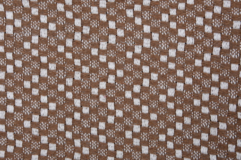 May include: Brown and white checkered fabric with a woven texture.