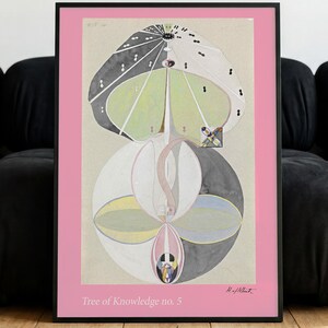 May include: A framed art print titled Tree of Knowledge no. 5, featuring a symmetrical abstract composition of organic shapes in shades of gray, green, yellow, and white, set against a solid pink border with a black frame, measuring 24x36 inches.