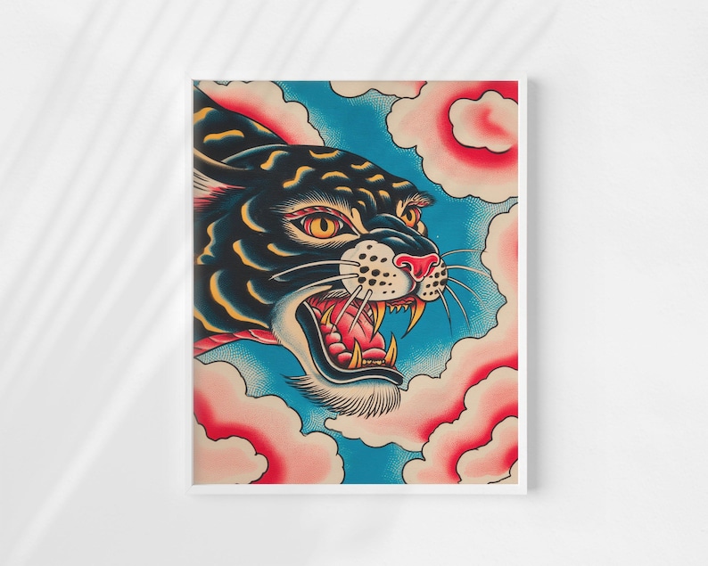May include: A rectangular art print featuring a stylized black panther head with yellow eyes and an open mouth showing sharp teeth. The panther is surrounded by pink, cloud-like shapes against a textured blue background, all within a white frame.