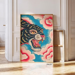 May include: A framed rectangular wall art print measuring 24x36 inches featuring a stylized illustration of a black panther head with yellow eyes and an open mouth showing teeth, set against a background of blue sky and pink clouds.