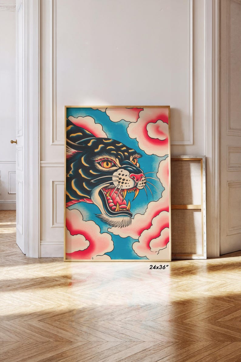 May include: A framed rectangular wall art print measuring 24x36 inches featuring a stylized illustration of a black panther head with yellow eyes and an open mouth showing teeth, set against a background of blue sky and pink clouds.