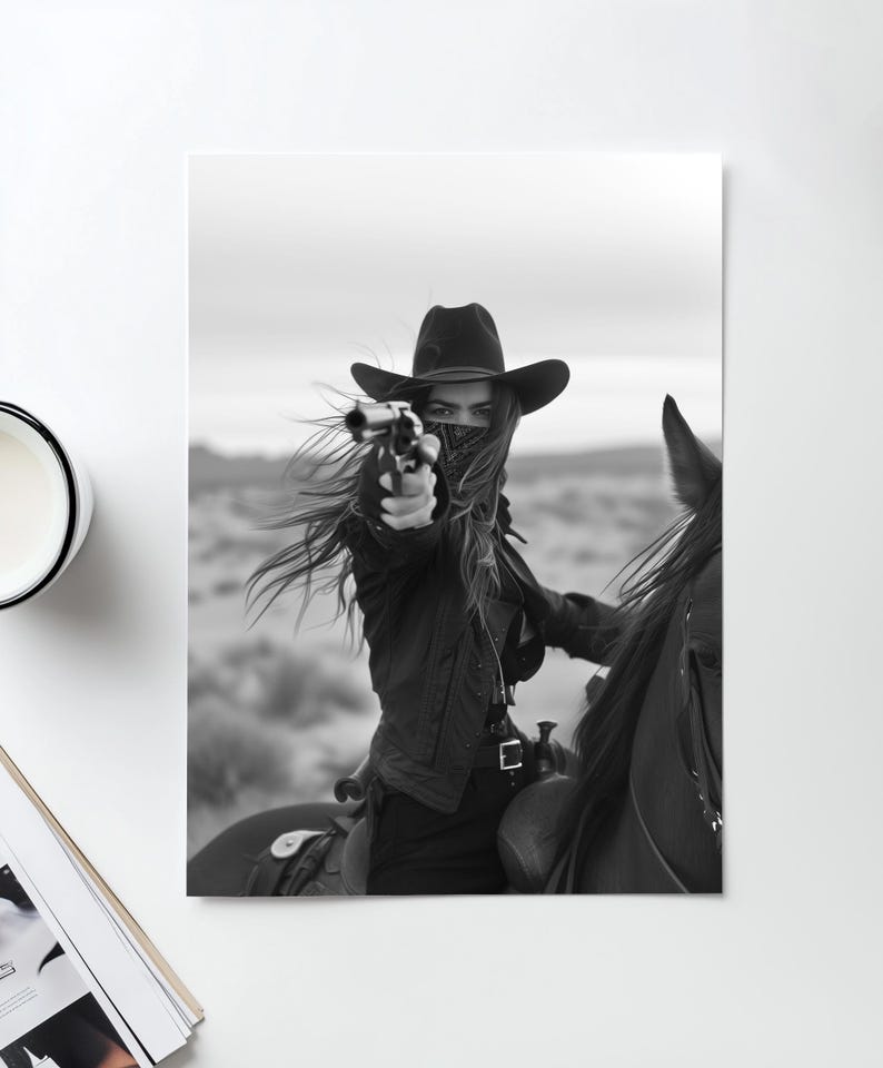 May include: A woman wearing a black cowboy hat and a black bandana over her face is riding a horse. She is holding a gun in her right hand and pointing it forward. The photo is in black and white.