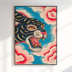 May include: A framed art print featuring a black panther with yellow eyes and an open mouth showing teeth, set against a bright blue background with stylized pink and white clouds. The panther has yellow highlights on its fur and a red nose.