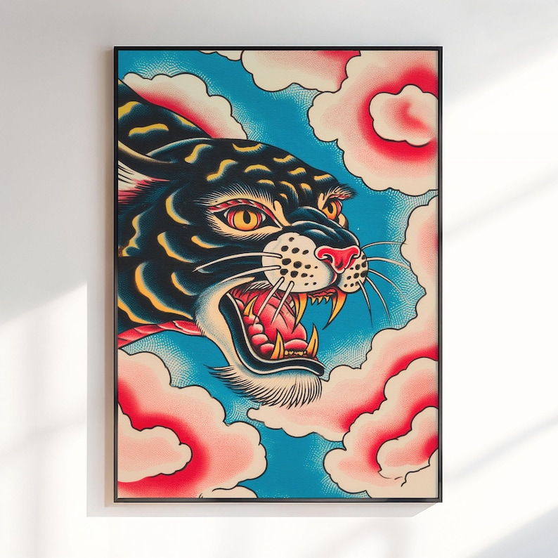 May include: A framed art print featuring a black panther with yellow eyes and an open mouth showing teeth, set against a bright blue background with stylized pink and white clouds. The panther has yellow highlights on its fur and a red nose.