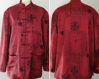 May include: A red Chinese-style jacket with black Chinese characters and symbols printed all over. The jacket has a mandarin collar and a button closure.