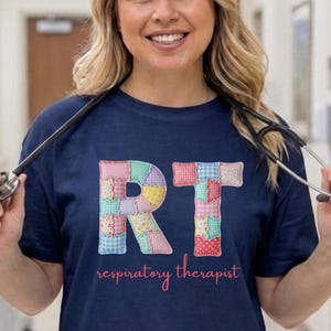 May include: A white ceramic mug with a black handle and the text "But First, Coffee" in a bold, black font. The mug is filled with a dark liquid, likely coffee, and rests on a light-coloured surface.