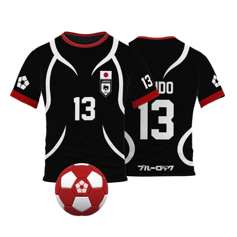 May include: Black soccer jersey with white accents and the number 13 on the front and back. The jersey has a red trim and a small Japanese flag with the word "JAPAN" on the front. A red and white soccer ball is in the foreground.