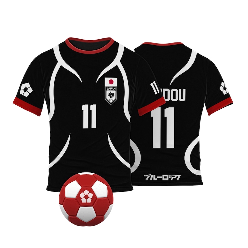 May include: Black soccer jersey with white accents and the number 11 on the front. The jersey has the Japanese flag and the words "JAPAN JFA" on the chest. The back of the jersey has the number 11 and the word "DOU" on the collar. The jersey is next to a red and white soccer ball.