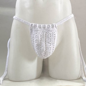 May include: White crocheted underwear with a low-rise cut and adjustable ties. The underwear is made with a delicate, open-weave pattern.