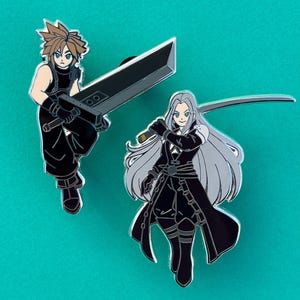 May include: Two enamel pins featuring characters from Final Fantasy VII. One pin depicts a character with spiky blonde hair holding a large sword. The other pin shows a character with long silver hair holding a katana. Both pins are on a teal background.